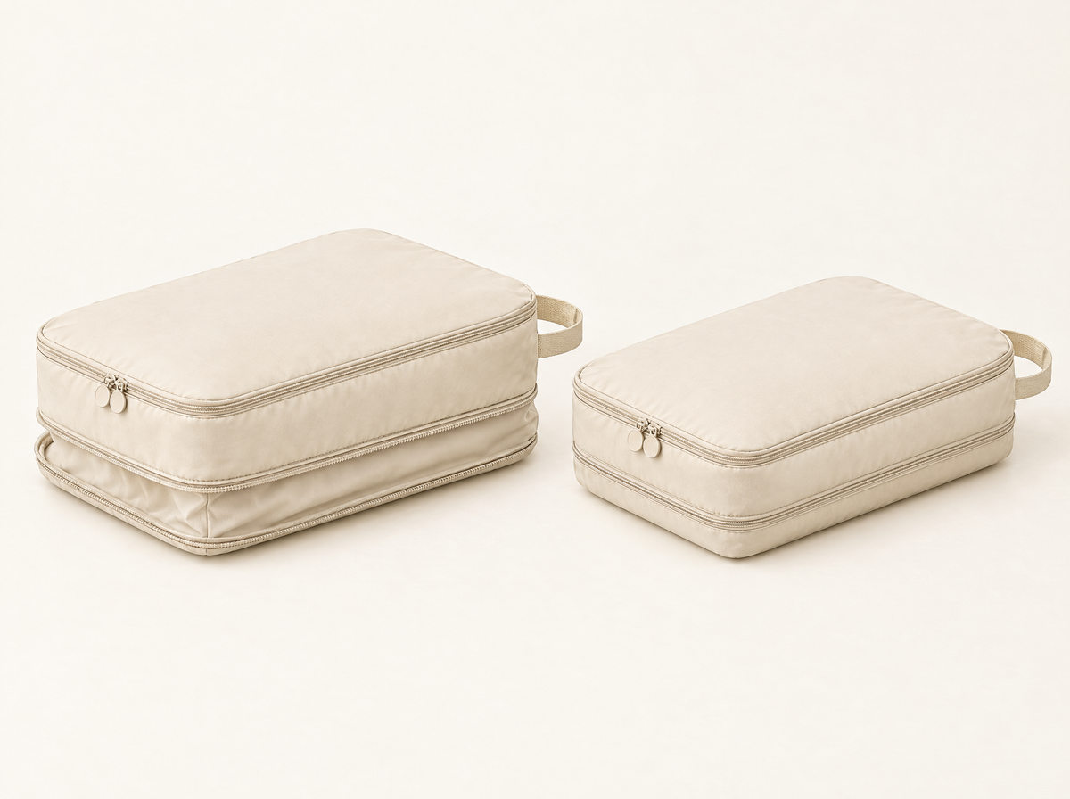 Illustration of a beige cube: expansion panel open on the left, compression zip closed on the right